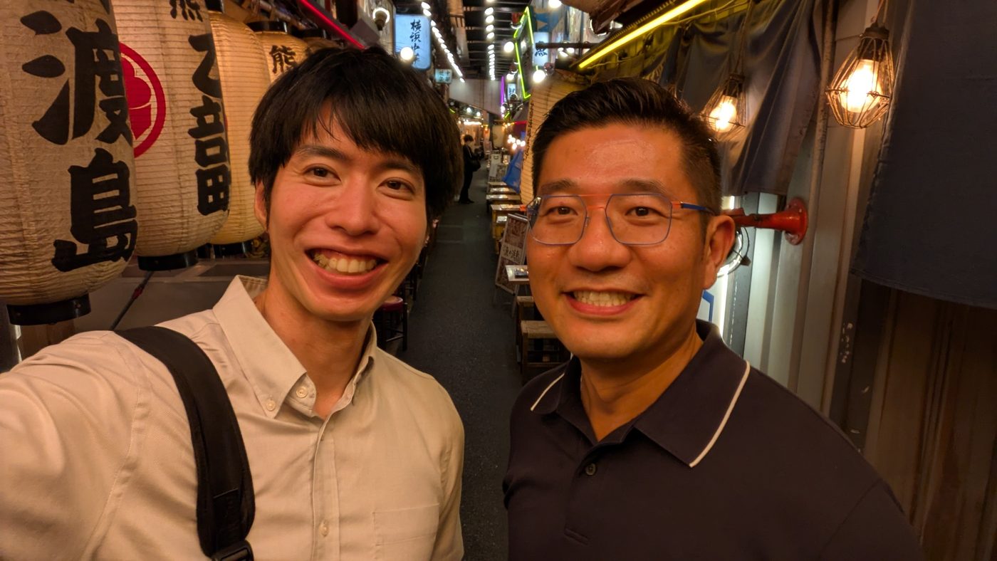 Guests with the guide in a lantern-lit izakaya alley in Shimbashi