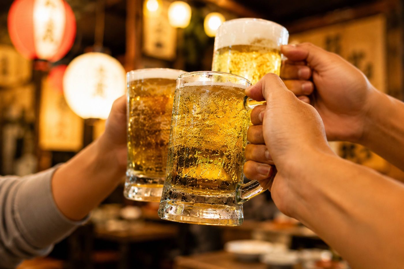 Three beer mugs clinking together
