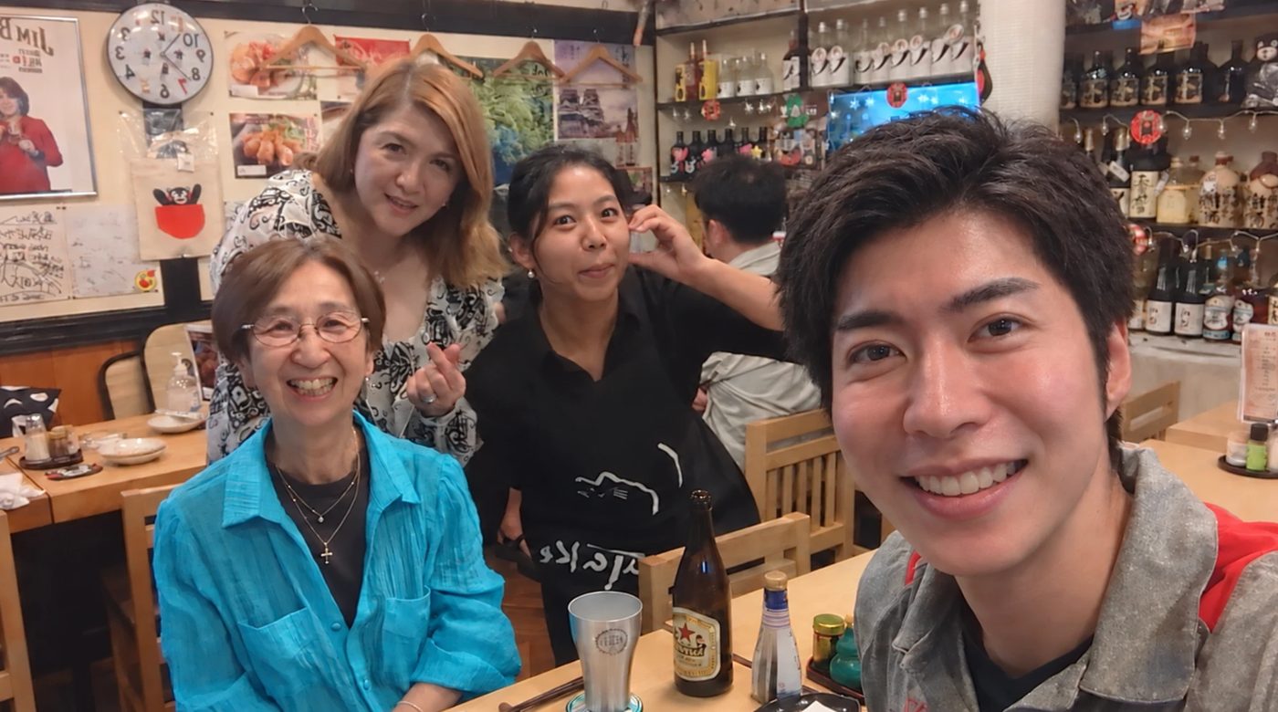 Guests and the guide at a cosy izakaya table