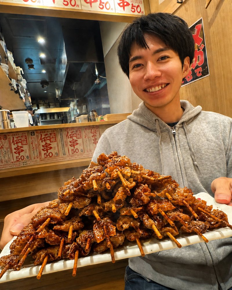 Kenichi, your guide, holding a tray of grilled skewers