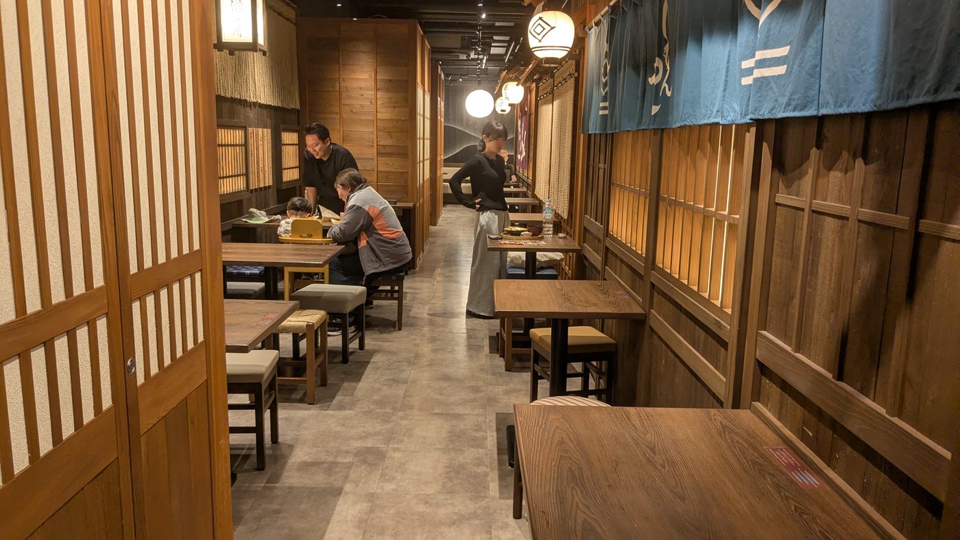 Interior of a wooden izakaya with lanterns