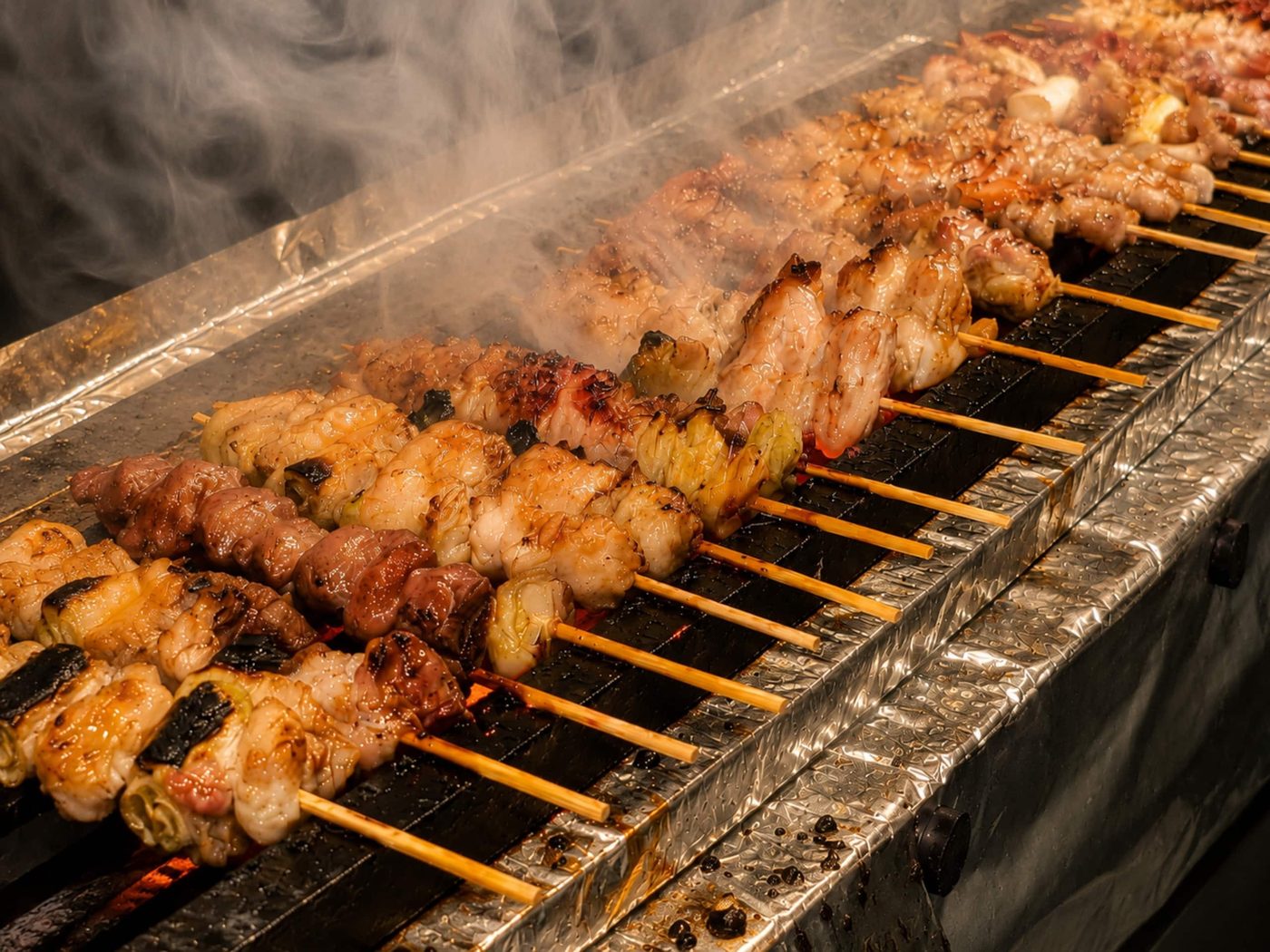 Chicken skewers grilling over charcoal